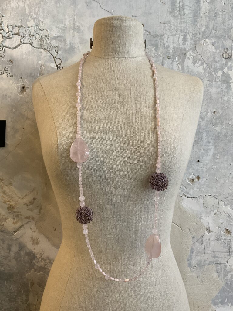 Lange halsketting met gehaakte details en parels uit rozenkwarts edelstenen van het Griekse juwelenmerk Taim