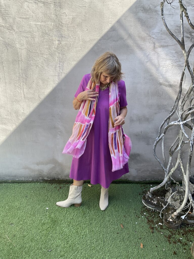 Kleurrijke, creatieve en aparte mode voor dames in hartje Gent. Halflange jurk in stretchkatoen met V-hals en korte mouwen in paars roze kleur van Anna Seravalli.